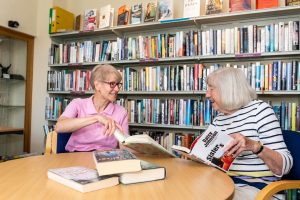 People reading books at Hudson House, Reeth Information Centre